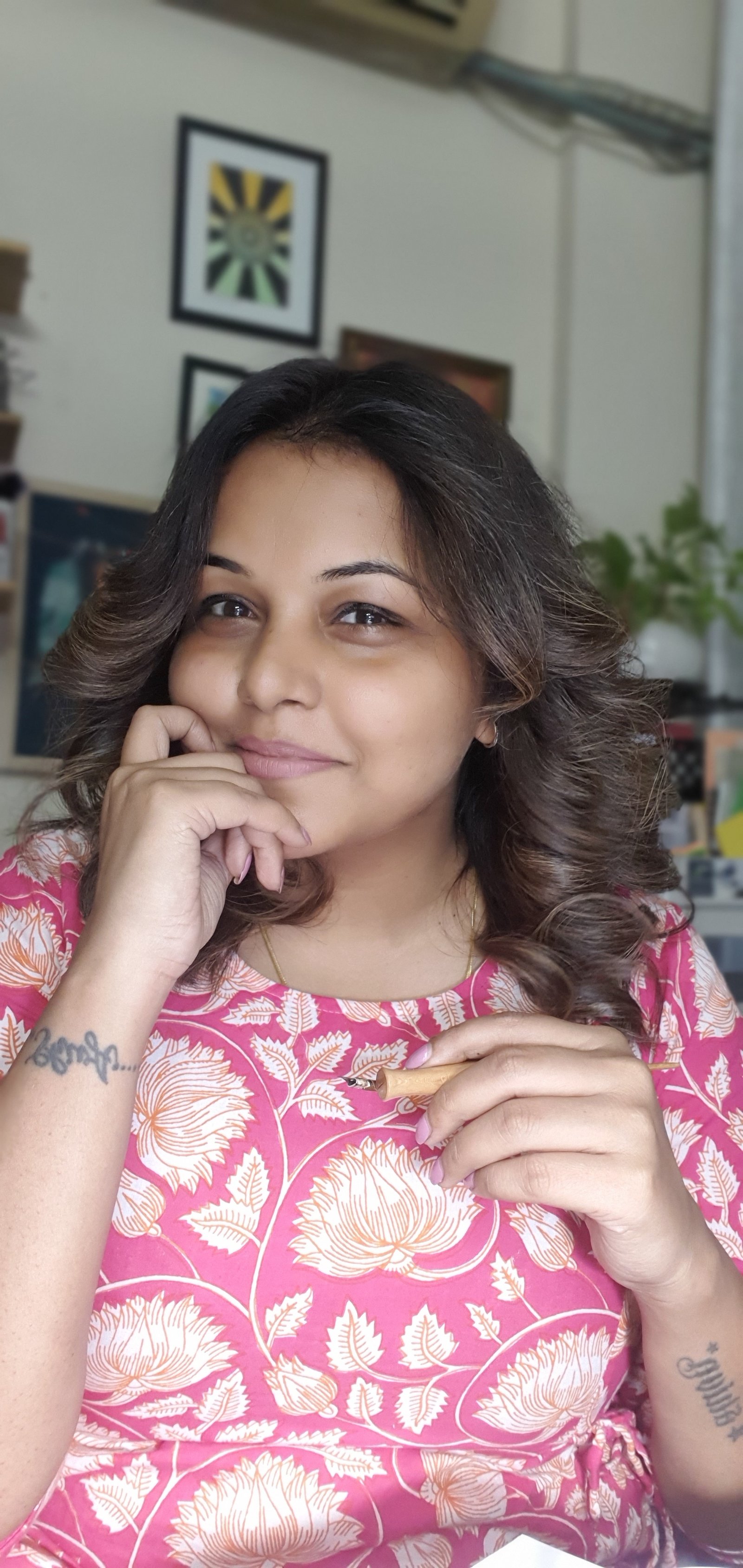 Raghunita Gupta in her studio, holding an oblique pen holder