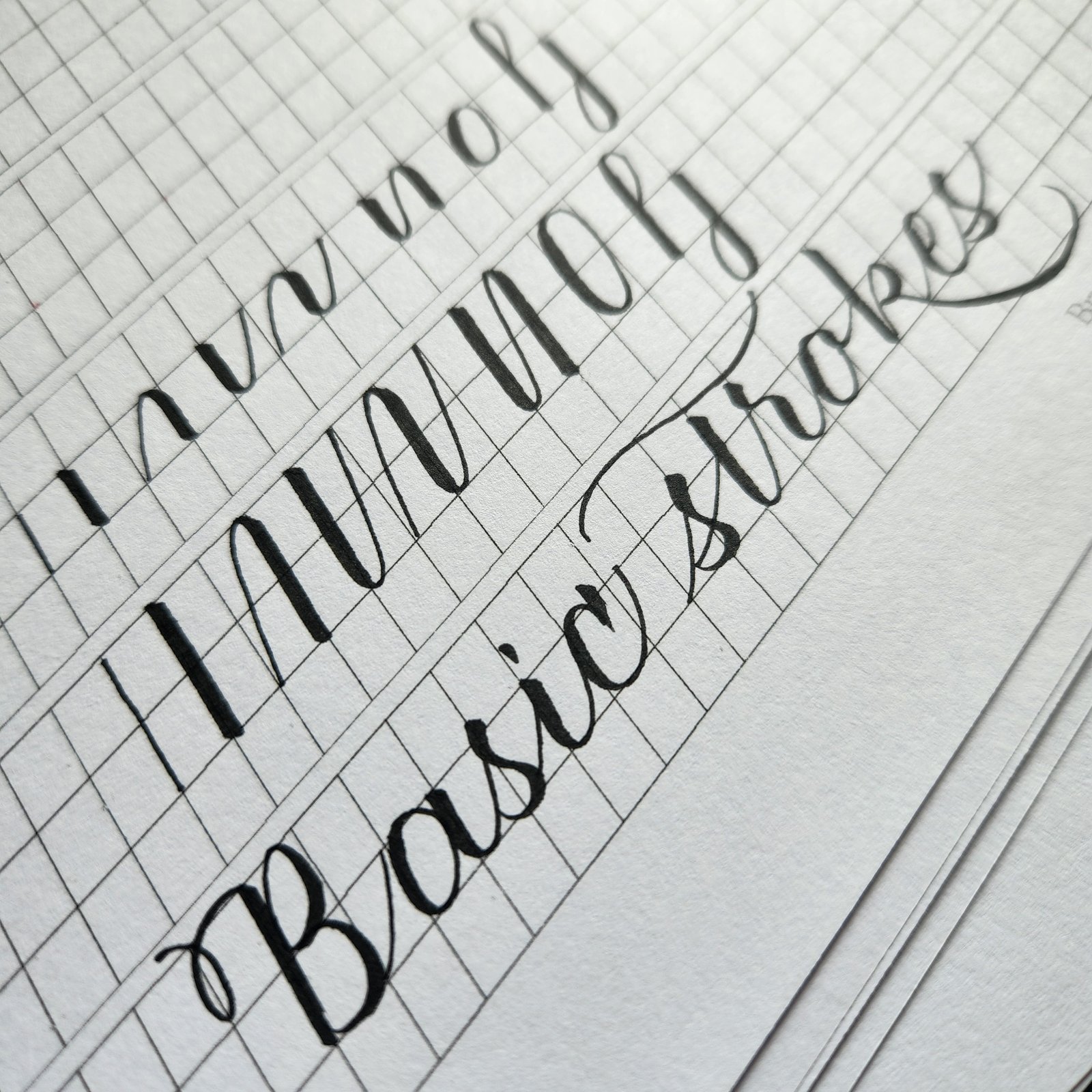 Basic stroke drills in black brush pen on grid paper