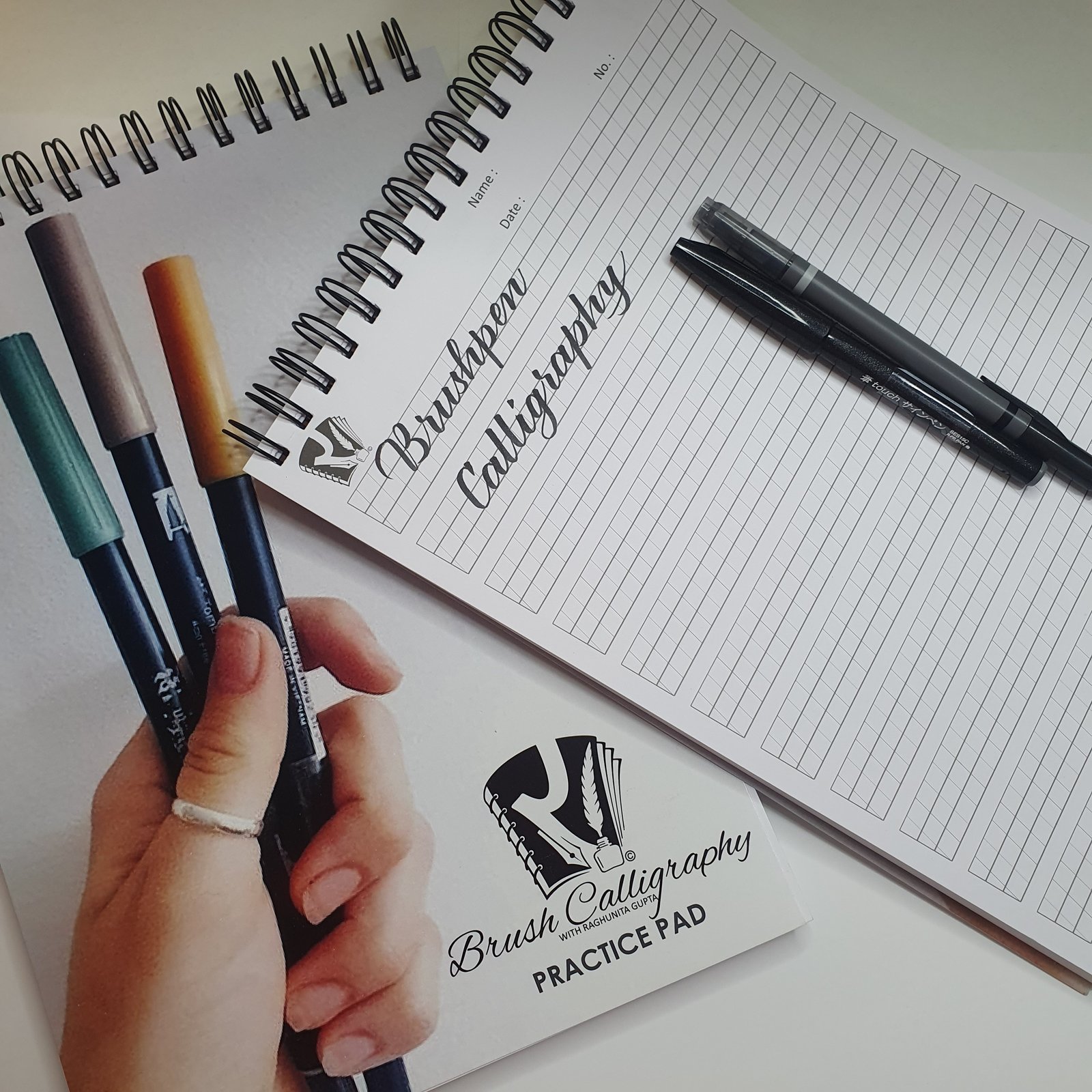 Brush pens and Brush Calligraphy practice pads from the course kit